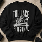 Black sweatshirt with distressed graphic of a turtle on a treadmill, reading "The Pace Is Personal".