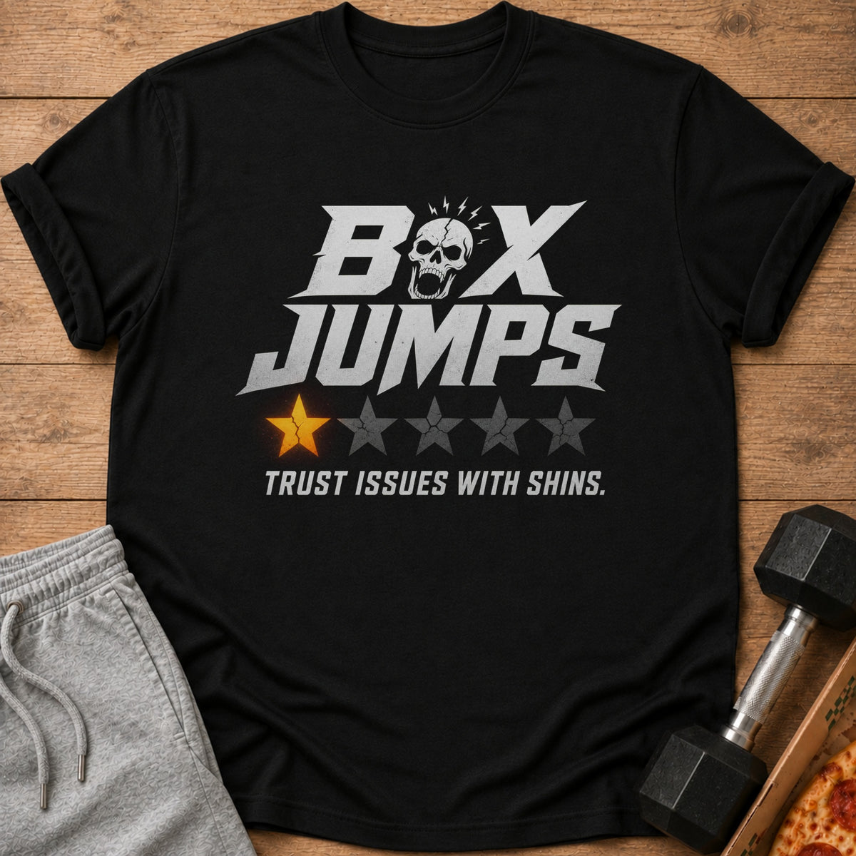 Black t-shirt with "Box Jumps" text, skull graphic, one yellow star, and "Trust Issues With Shins."