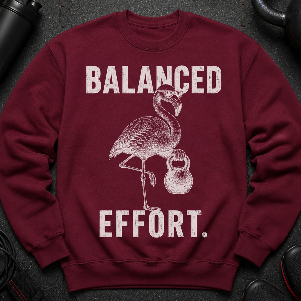 Maroon sweatshirt with a flamingo lifting a kettlebell and text "BALANCED EFFORT."
