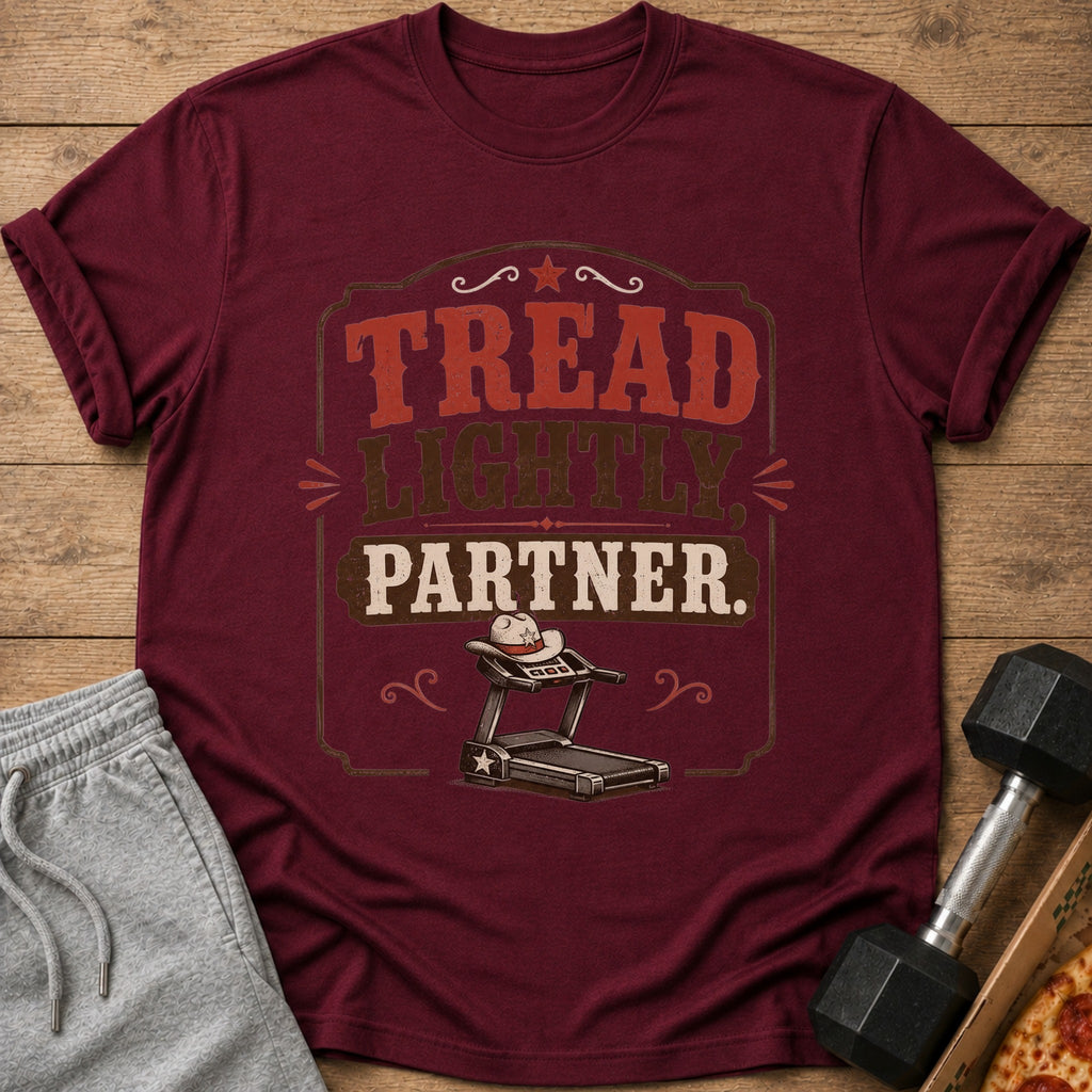 Maroon t-shirt with "Tread Lightly, Partner." text and a cowboy hat on a treadmill.
