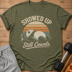 Olive t-shirt with panda lying down and text "Showed Up. Still Counts."