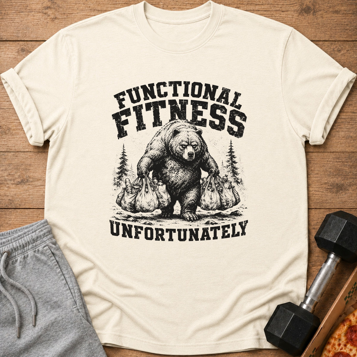 Cream t-shirt with graphic of bear carrying grocery bags, text "FUNCTIONAL FITNESS UNFORTUNATELY".