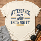 Cream t-shirt with "Attendance Over Intensity Anti-Hustle" graphic and whistle.