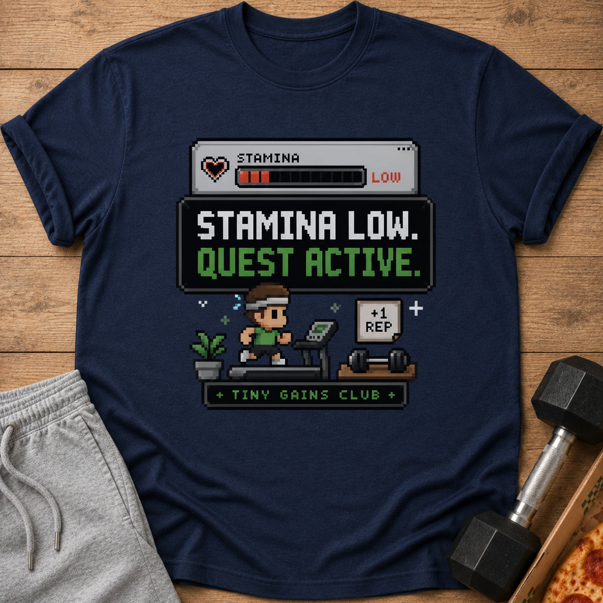 Navy t-shirt with pixelated "Stamina Low. Quest Active. +1 Rep" gaming graphic.