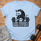 Light blue t-shirt with a sad possum lifting a barbell, text reads "LOW ENERGY. HIGH EFFORT."