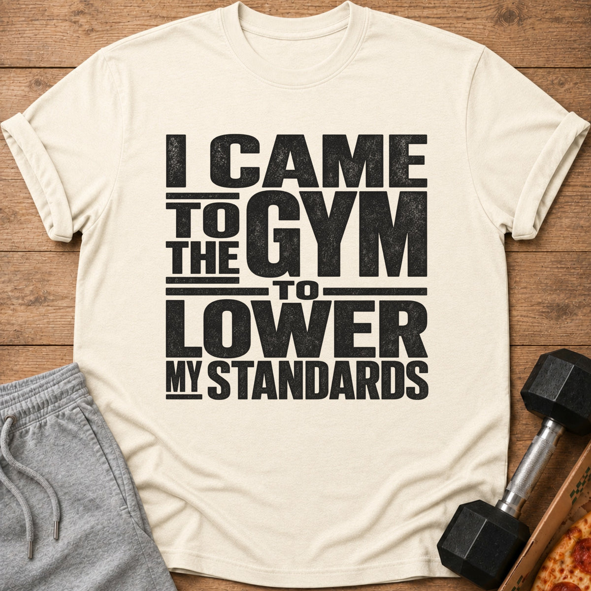Off-white t-shirt with black text reading "I came to the gym to lower my standards."
