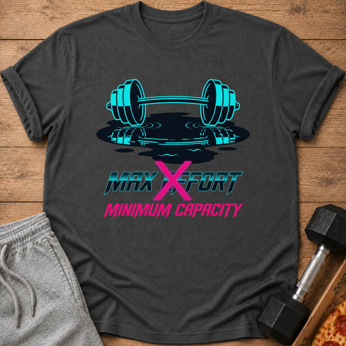 Dark gray t-shirt with aqua barbell graphic and "MAX EFFORT MINIMUM CAPACITY" text.
