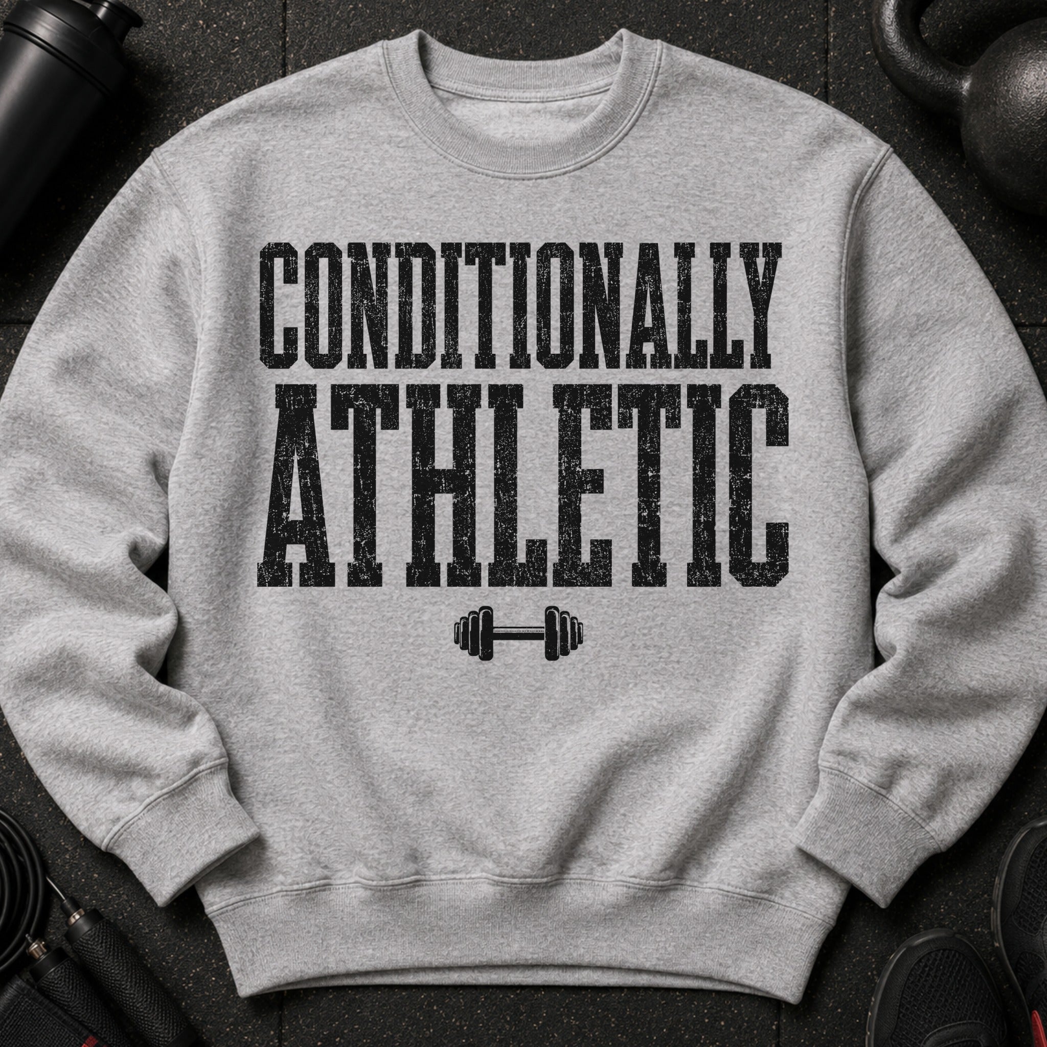 Grey crewneck sweatshirt with text "CONDITIONALLY ATHLETIC" and dumbbell graphic.