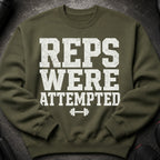 Green sweatshirt with distressed white text and barbell graphic reading "REPS WERE ATTEMPTED."
