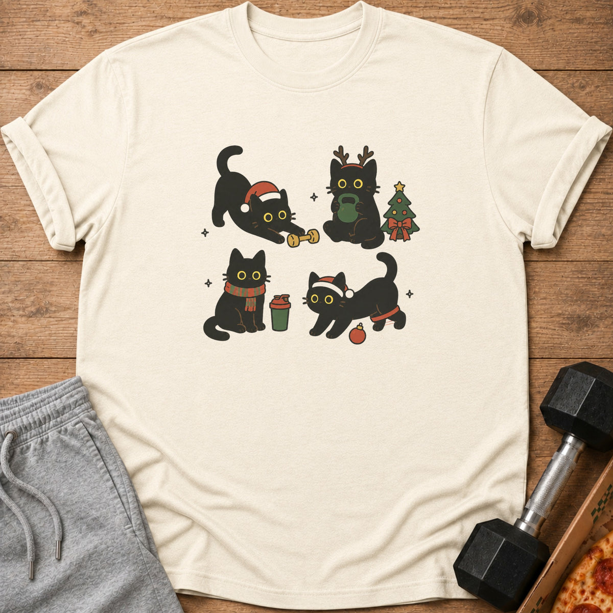 Four black cats celebrate Christmas and fitness on a cream t-shirt.