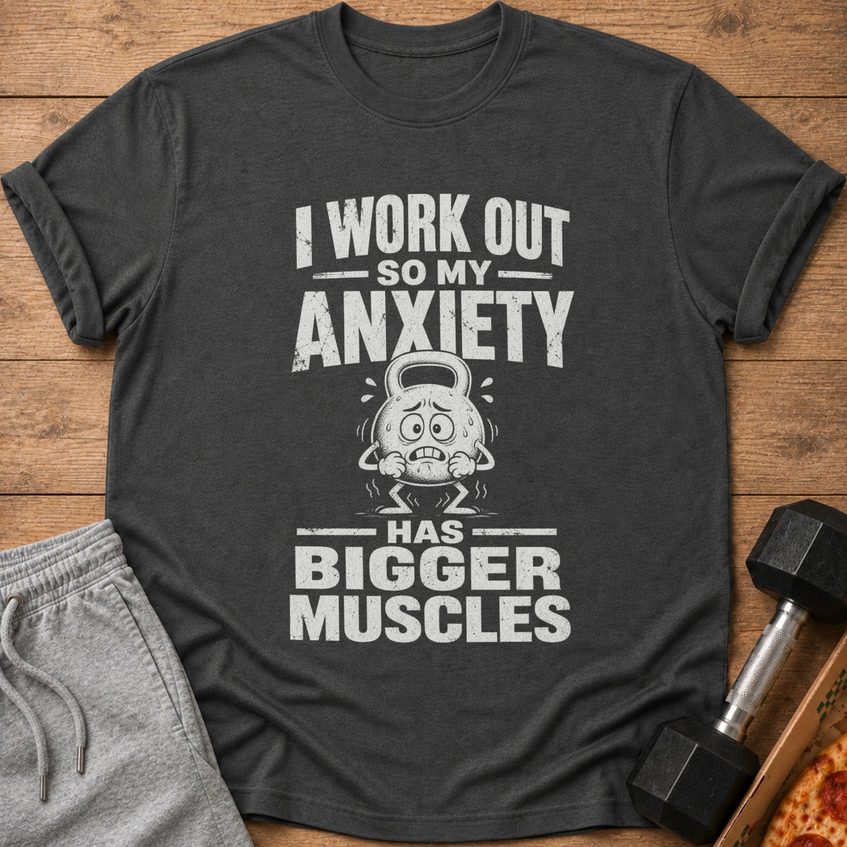 Dark grey t-shirt with text "I WORK OUT SO MY ANXIETY HAS BIGGER MUSCLES".