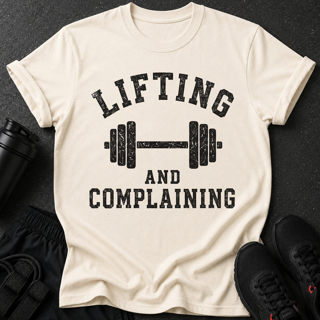 Cream t-shirt with black distressed text and a barbell graphic.