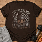 Brown t-shirt with "Tis The Season" text, pumpkin, skeleton hand, and workout equipment.