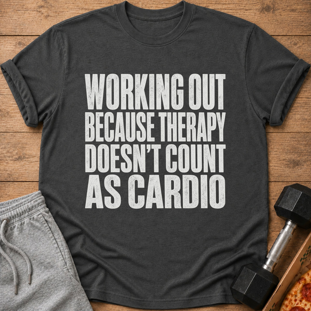 Dark grey t-shirt with white text "WORKING OUT BECAUSE THERAPY DOESN'T COUNT AS CARDIO".