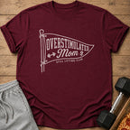 Maroon t-shirt with "Overstimulated Mom Still Lifting Club" text and graphics.