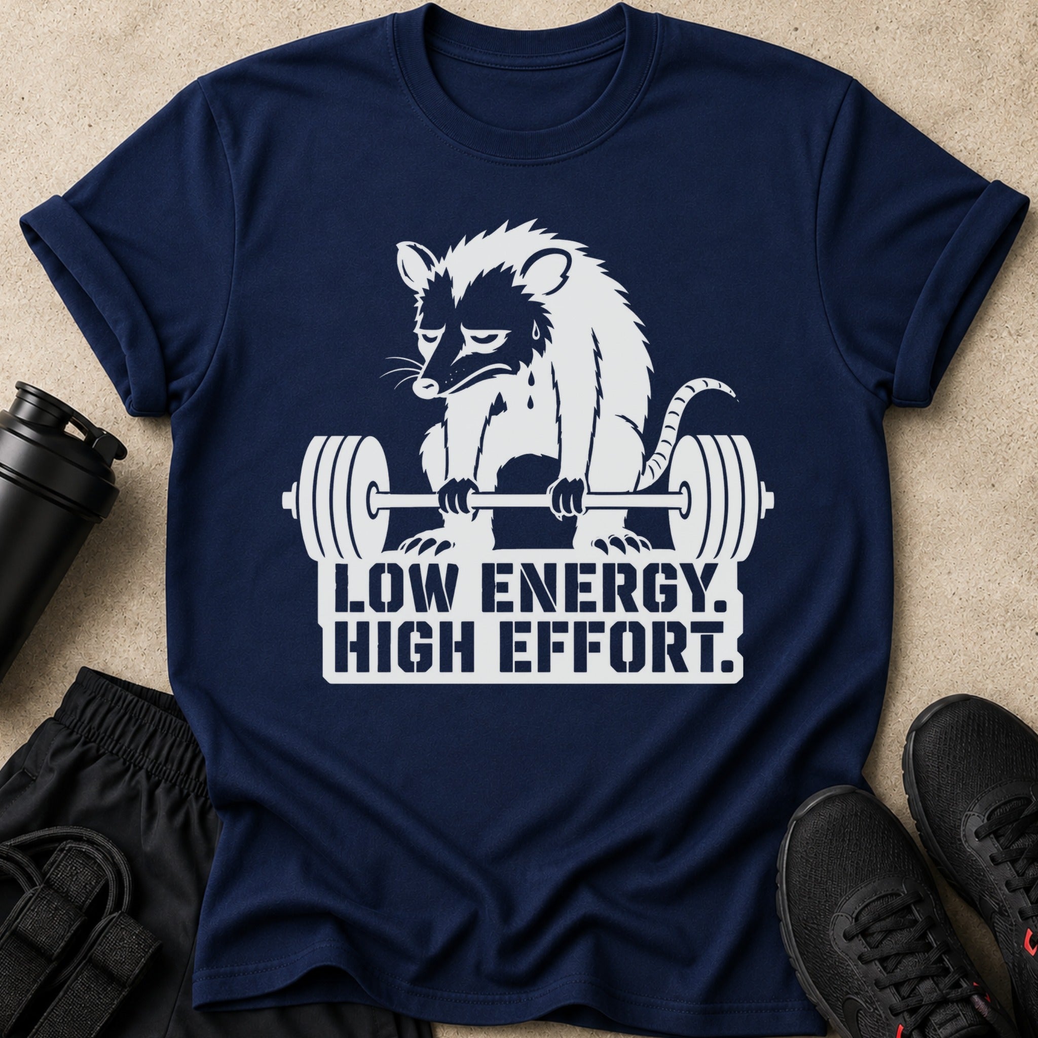 Navy t-shirt with white raccoon lifting weights and text "LOW ENERGY. HIGH EFFORT."