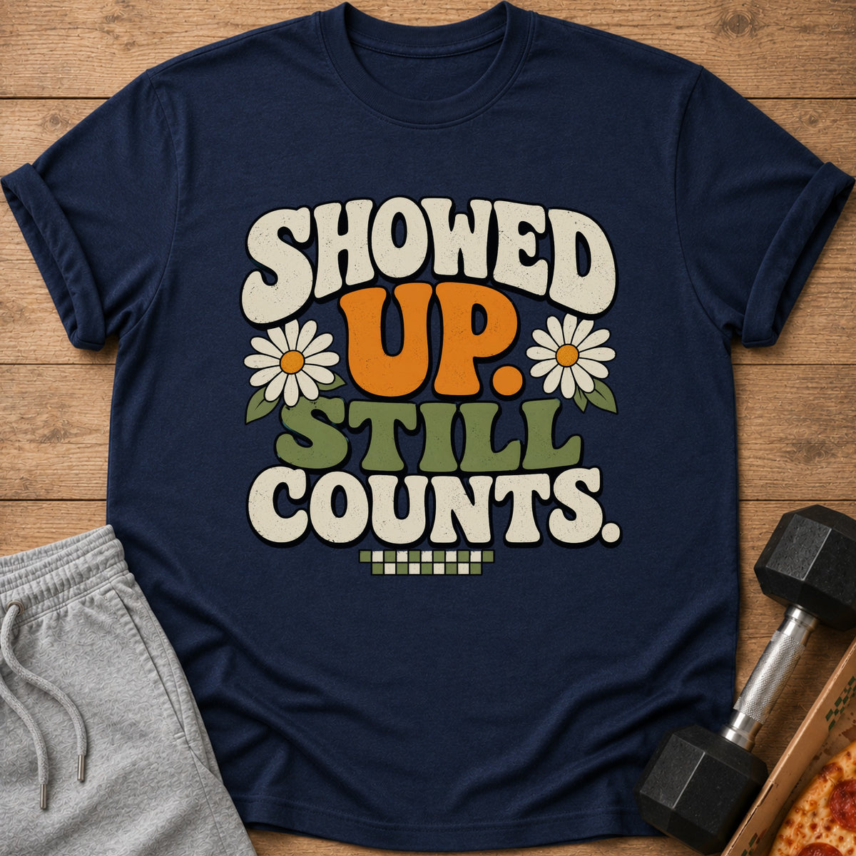 Navy t-shirt with "SHOWED UP. STILL COUNTS." text and floral graphics.
