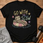 Black t-shirt with sloth wearing heart sunglasses on a float and text "GO WITH THE SLOW".