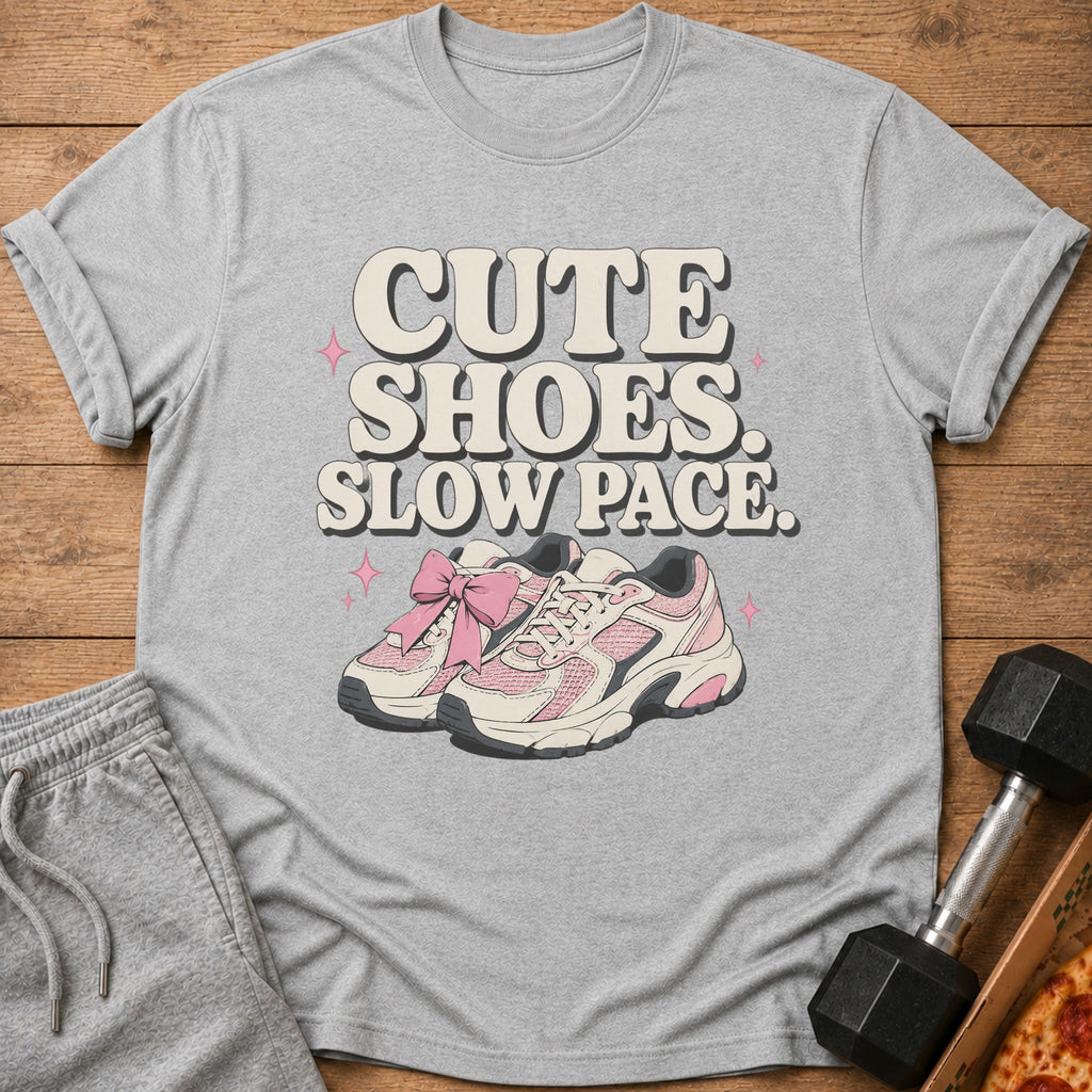 Gray t-shirt with pink and white sneakers and text "CUTE SHOES. SLOW PACE."