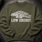 Green sweatshirt with an alligator sitting on dumbbells and text "LOW ENERGY."