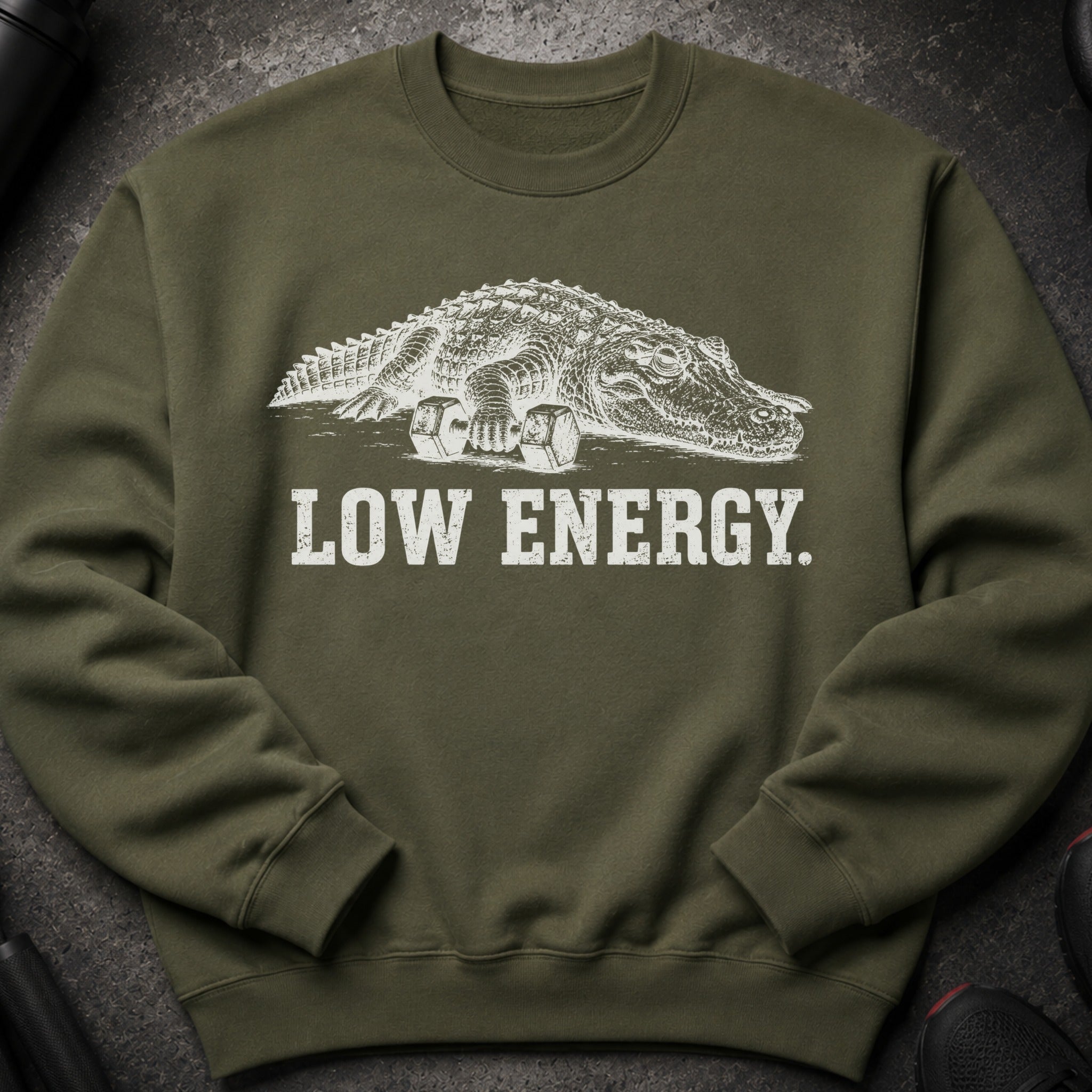 Green sweatshirt with an alligator sitting on dumbbells and text "LOW ENERGY."