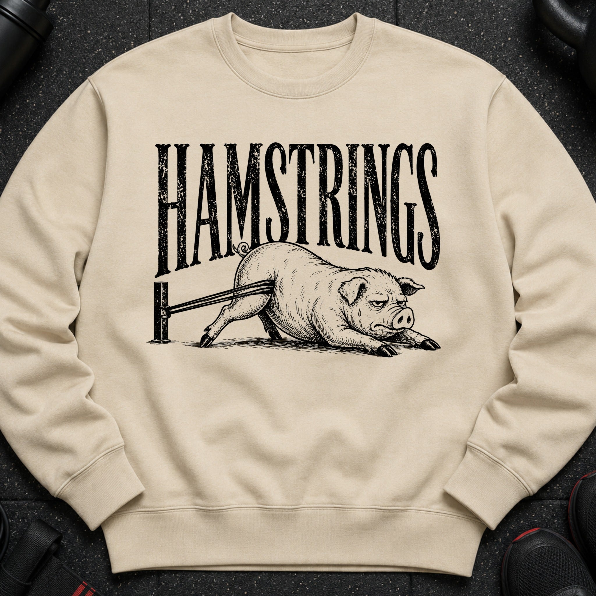 Sweatshirt with "HAMSTRINGS" text and a pig stretching a resistance band.