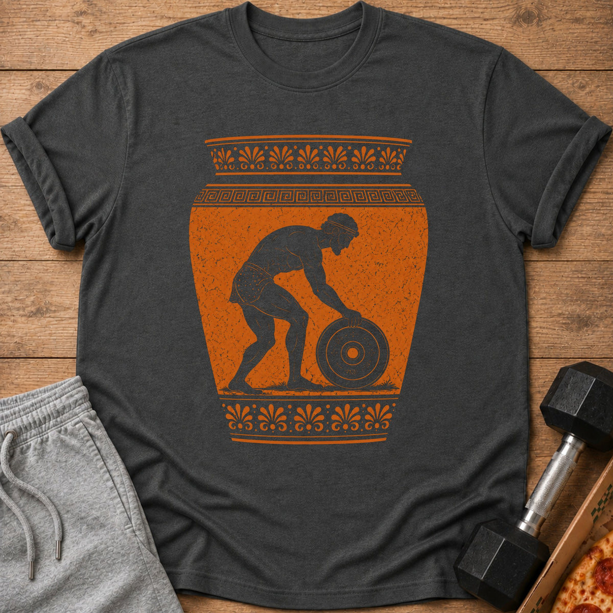 Dark grey t-shirt with ancient Greek artwork of a man lifting a weight.