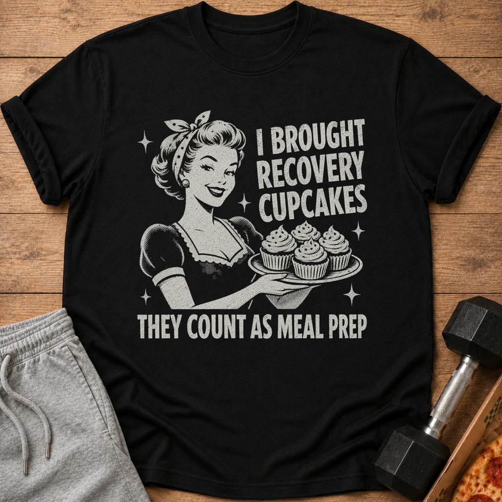 Black t-shirt with vintage woman holding cupcakes, text reads "I BROUGHT RECOVERY CUPCAKES THEY COUNT AS MEAL PREP".