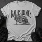 Kaleisthenics graphic on a grey t-shirt with a sad kale character doing a push-up.