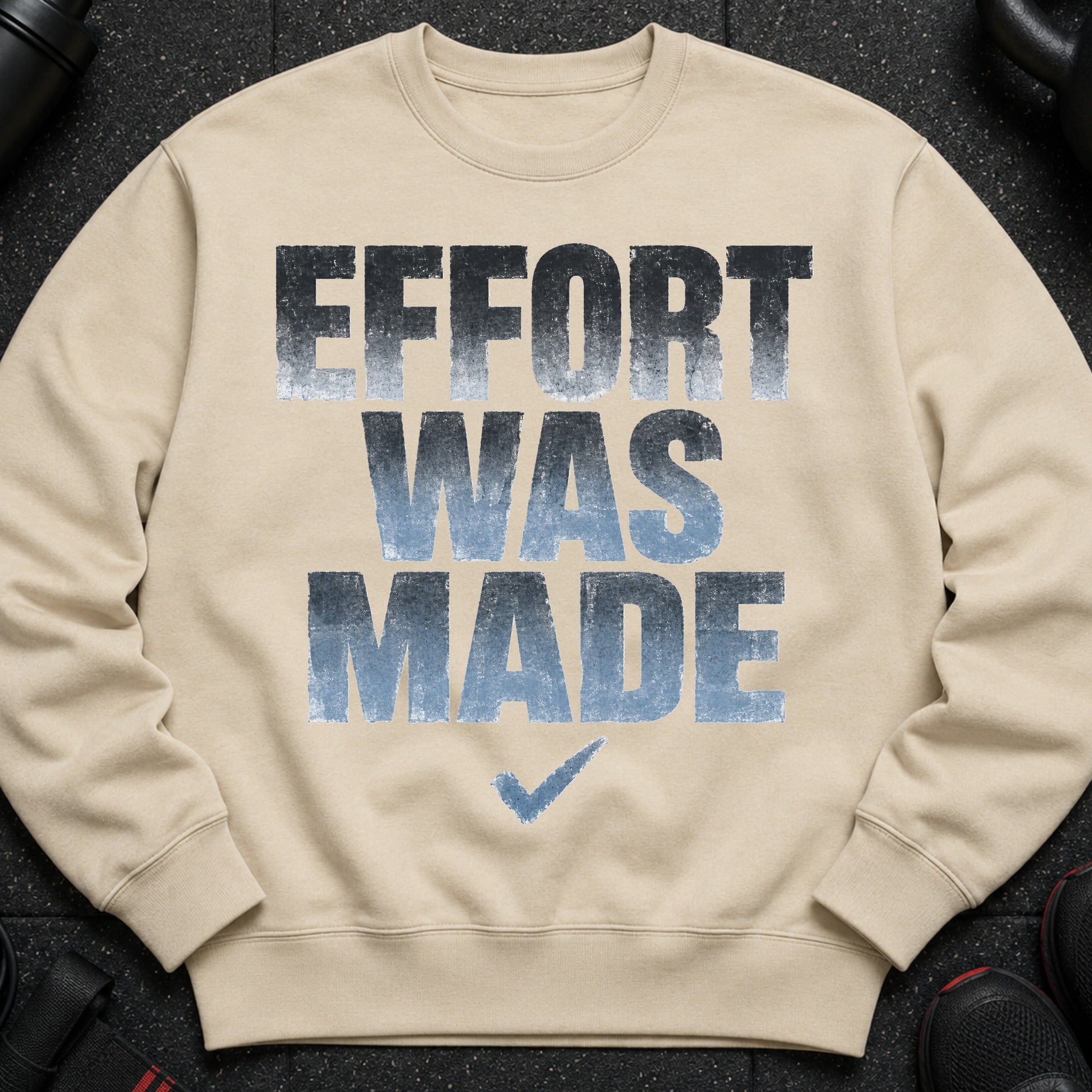 Tan crewneck sweatshirt with distressed "EFFORT WAS MADE" text and a checkmark graphic.