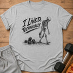 Grey t-shirt with black graphic of skeleton carrying shaker, "I Lived, Technically" text.