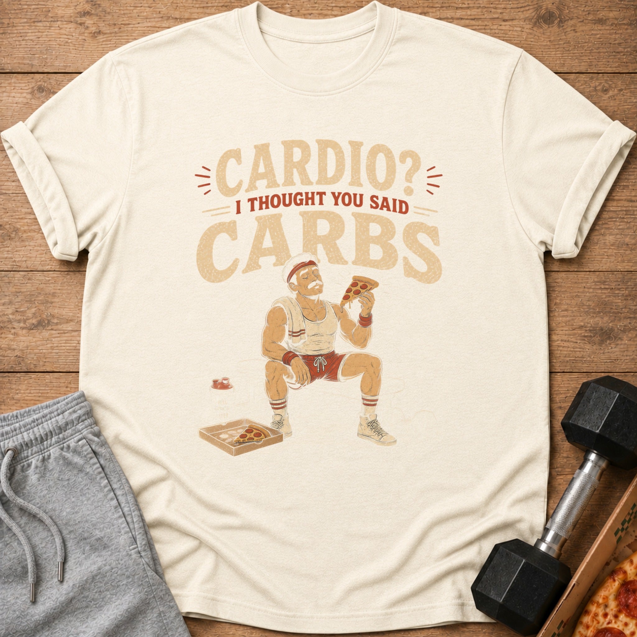Cream t-shirt with illustration "Cardio? I thought you said CARBS" and man eating pizza.