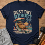 Navy t-shirt with capybara relaxing at a resort with text "REST DAY RESORT CHECKED IN CLOCKED OUT".
