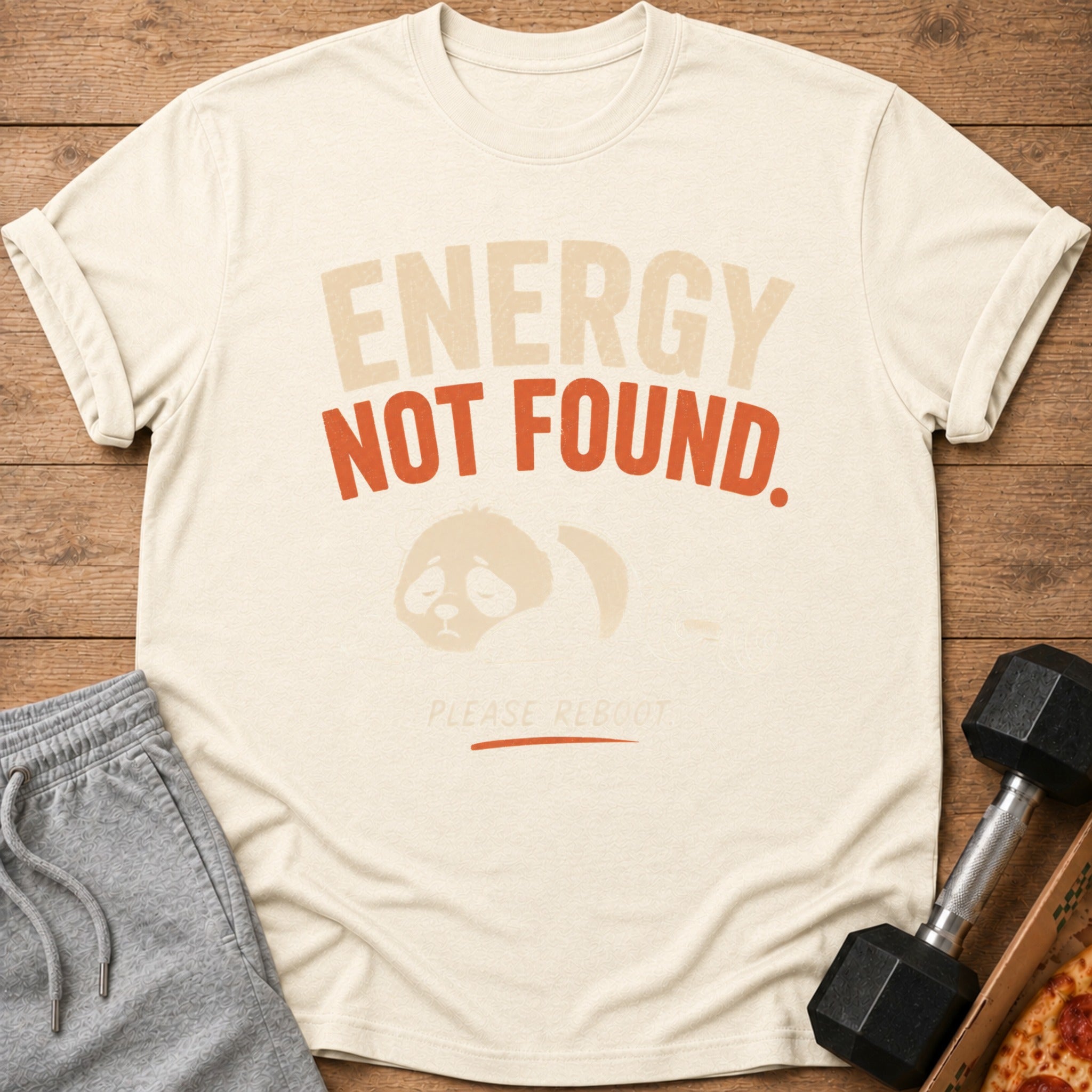 Cream t-shirt with "ENERGY NOT FOUND. PLEASE REBOOT" and a sad panda graphic.