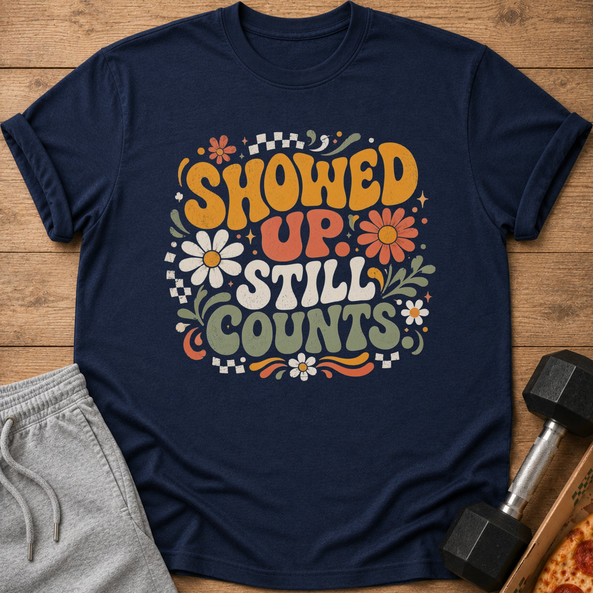 Navy t-shirt with distressed "Showed Up Still Counts" text and floral graphics.