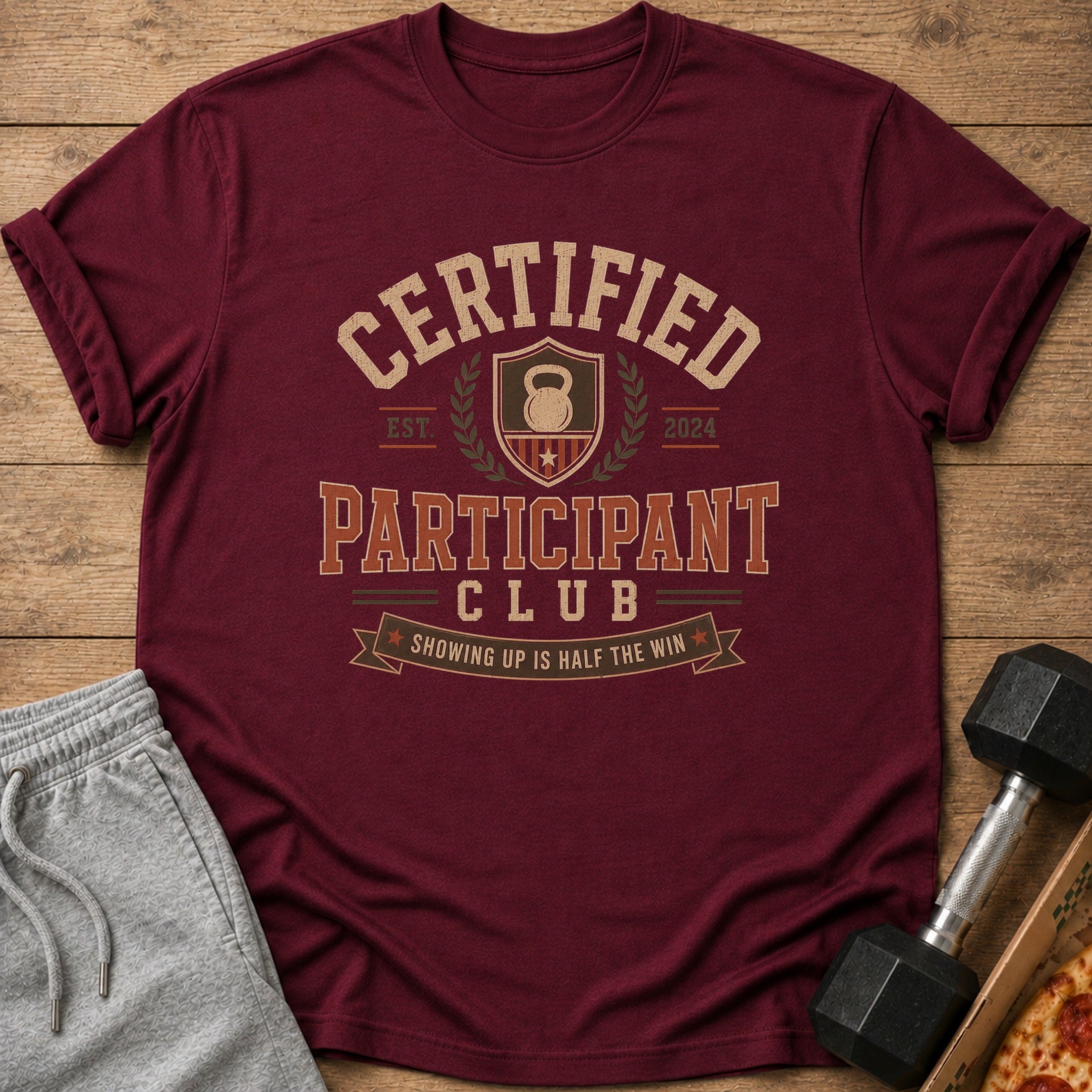 Maroon t-shirt with text "Certified Participant Club" and a kettlebell graphic.