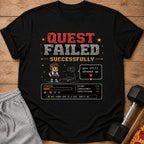 Black t-shirt with pixelated "QUEST FAILED SUCCESSFULLY" and workout stats.