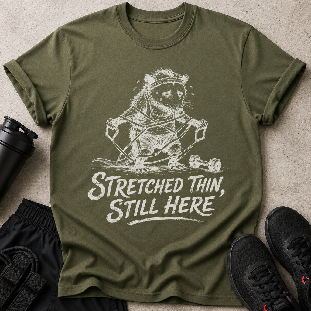 Olive green t-shirt with a distressed graphic of a raccoon exercising.