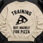Light tan sweatshirt with "TRAINING BUT MAINLY FOR PIZZA" text and a pizza slice graphic.