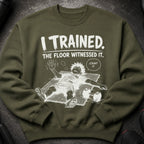 Green sweatshirt with "I TRAINED. THE FLOOR WITNESSED IT. COUNT IT." text and cartoon illustration.