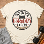 Cream t-shirt with "Certified Rest Day Expert Field Tested" graphic.