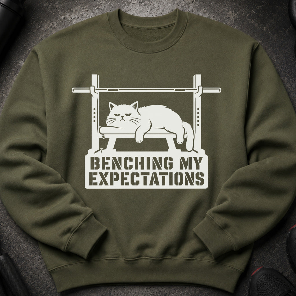 Green sweatshirt with white graphic of a grumpy cat on a weight bench and text.