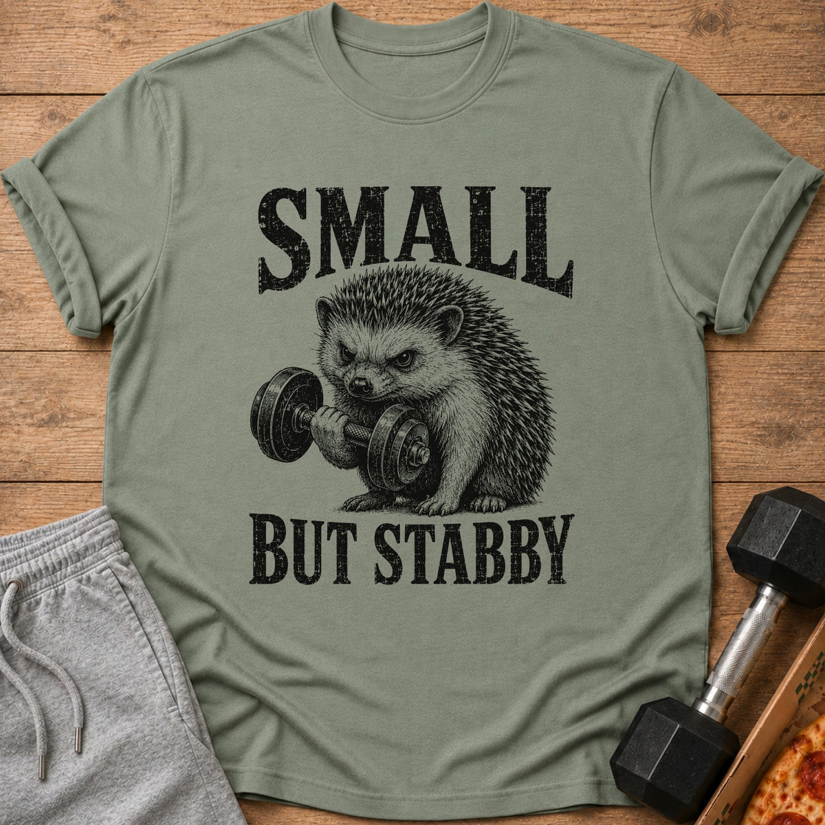 Green t-shirt with "SMALL BUT STABBY" text and a hedgehog lifting a dumbbell.