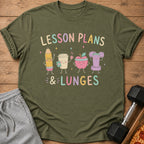 Green t-shirt with cartoon pencil, coffee cup, apple, and dumbbell reading "LESSON PLANS & LUNGES".