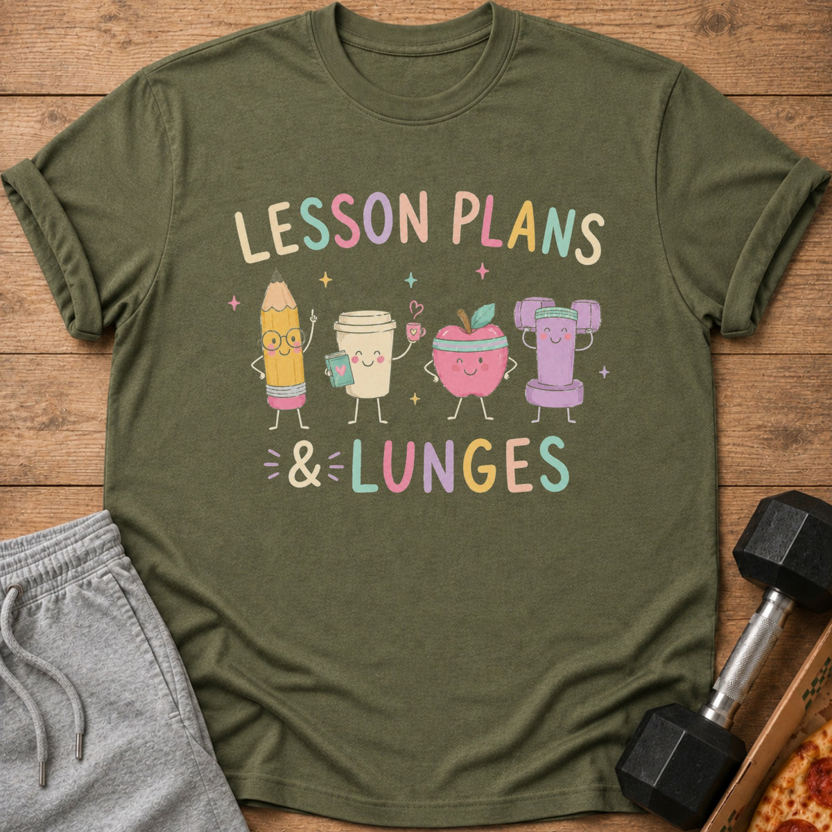 Green t-shirt with cartoon pencil, coffee cup, apple, and dumbbell reading "LESSON PLANS & LUNGES".