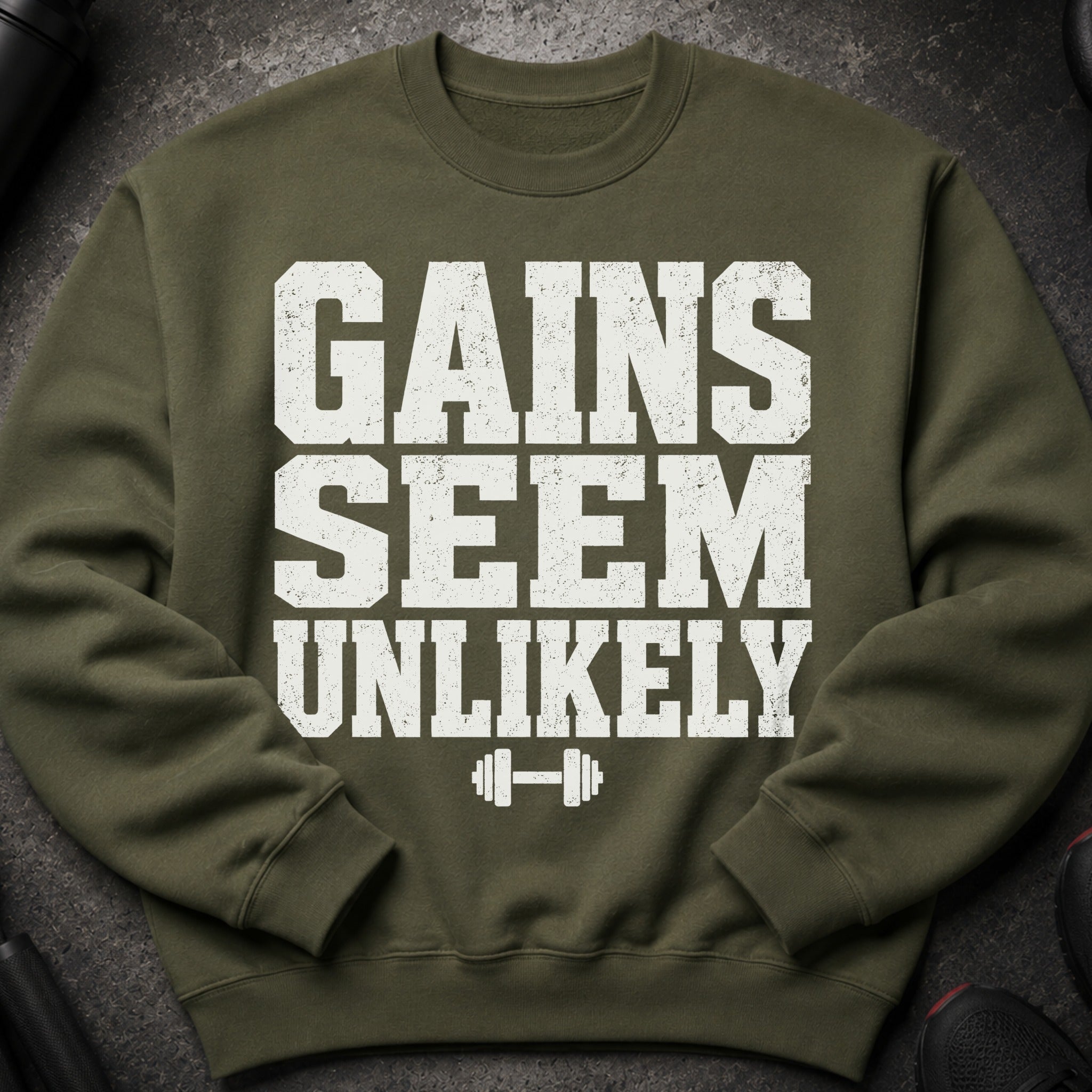 Olive green sweatshirt with white distressed text "GAINS SEEM UNLIKELY" and a dumbbell graphic.