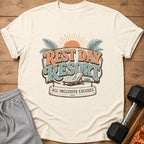 Cream t-shirt with "Rest Day Resort All Inclusive Excuses" graphic and beach chair.