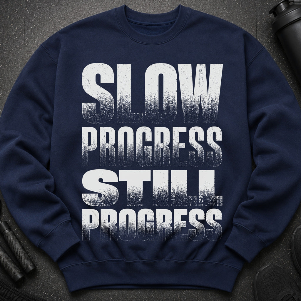 Navy sweatshirt with white textured text that reads "SLOW PROGRESS STILL PROGRESS".