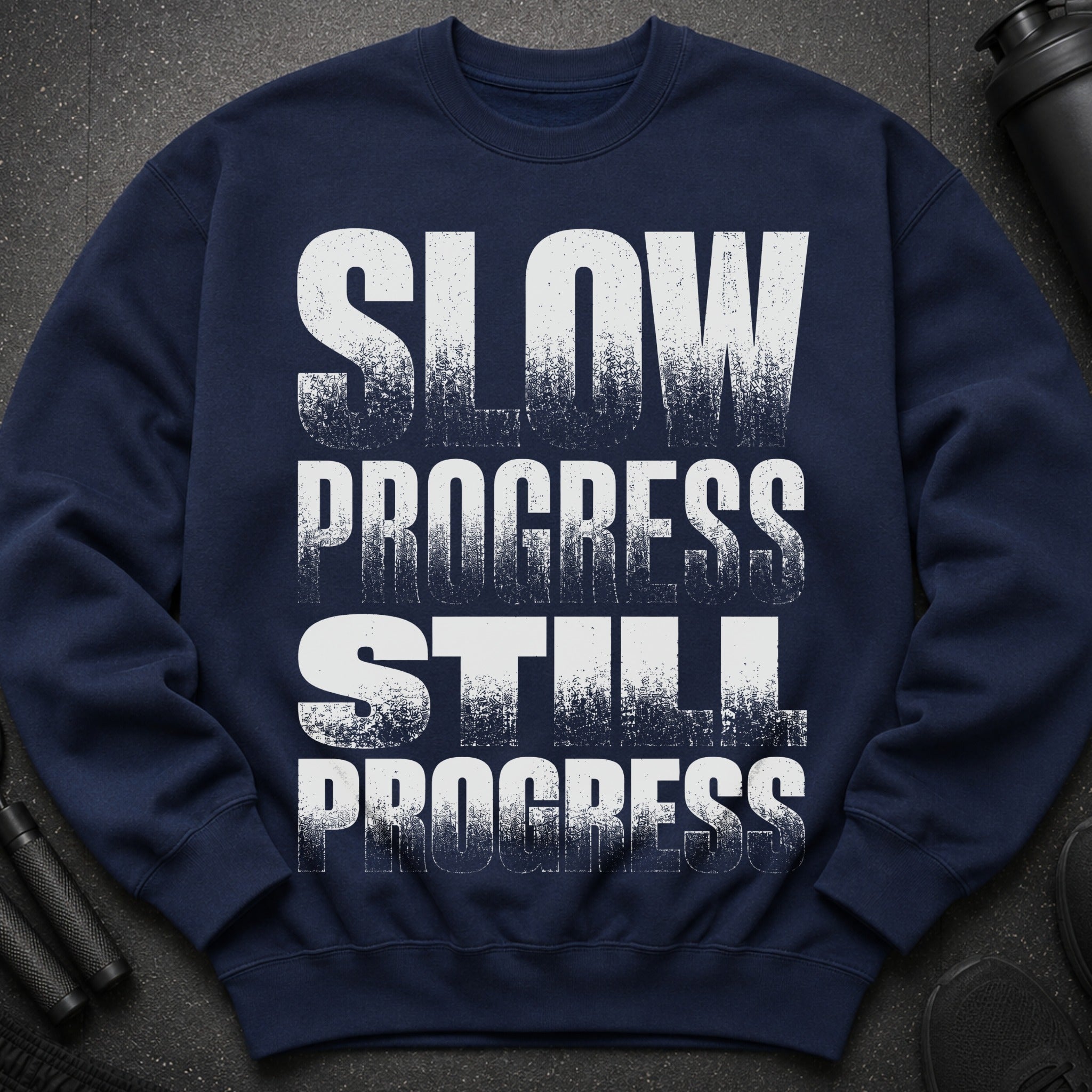 Navy sweatshirt with white textured text that reads "SLOW PROGRESS STILL PROGRESS".