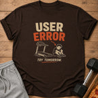 Brown t-shirt with "USER ERROR" graphic, treadmill, sad boy, and "TRY TOMORROW".